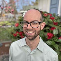 Person wearing glasses and smiling